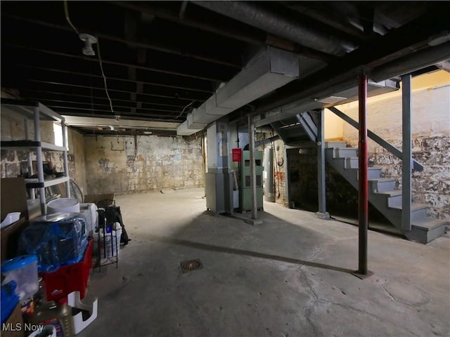 basement featuring gas water heater and heating unit