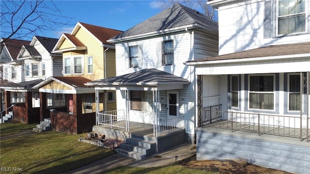 view of front of home with covered porch and a front lawn