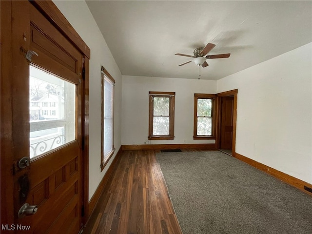 spare room featuring ceiling fan and dark hardwood / wood-style floors