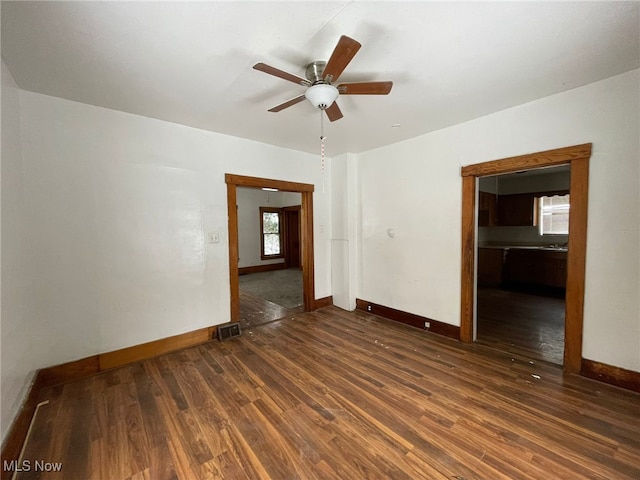 spare room featuring dark hardwood / wood-style floors and ceiling fan