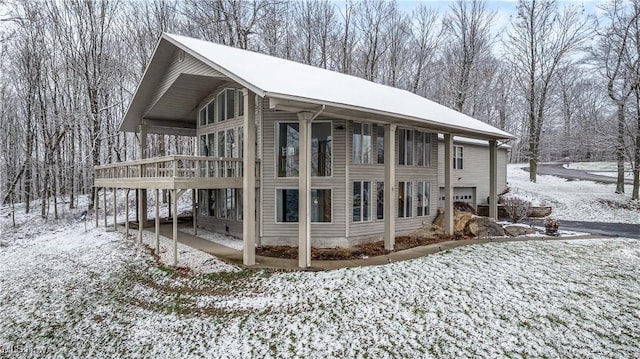 view of snowy exterior with a deck