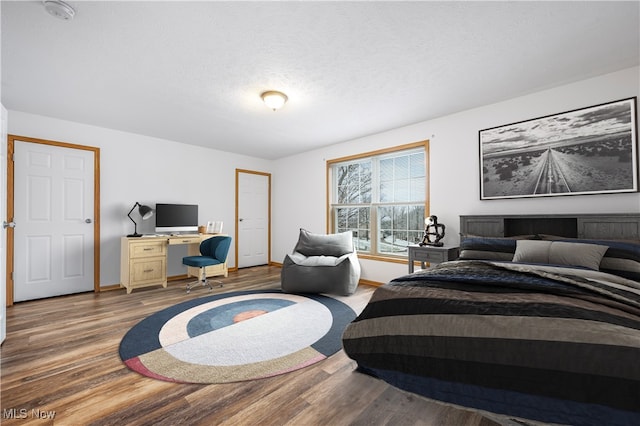 bedroom featuring a textured ceiling and hardwood / wood-style flooring