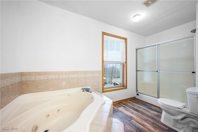 bathroom featuring hardwood / wood-style flooring, toilet, and independent shower and bath