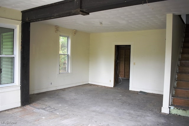 unfurnished room featuring a textured ceiling