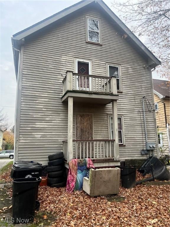 rear view of house featuring a balcony