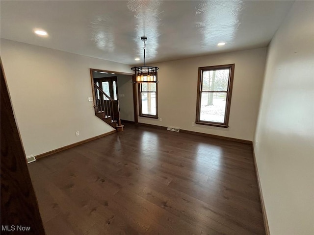 empty room featuring dark hardwood / wood-style flooring