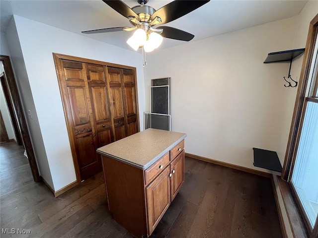 interior space with ceiling fan, dark hardwood / wood-style flooring, and a kitchen island