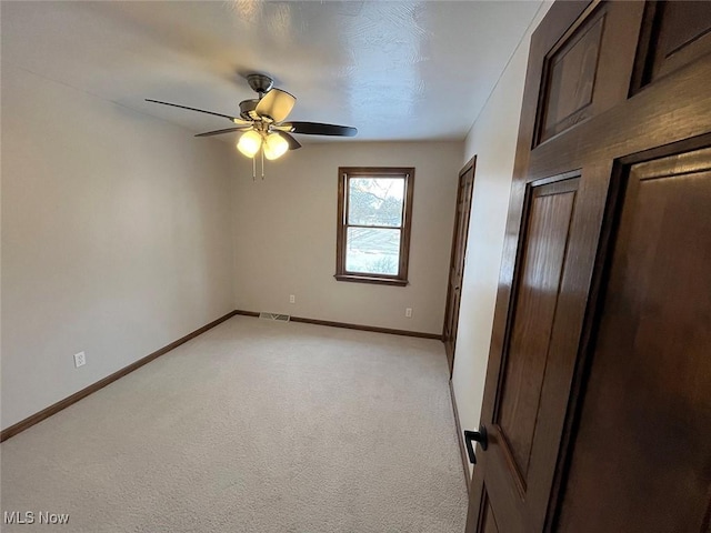 carpeted empty room with ceiling fan