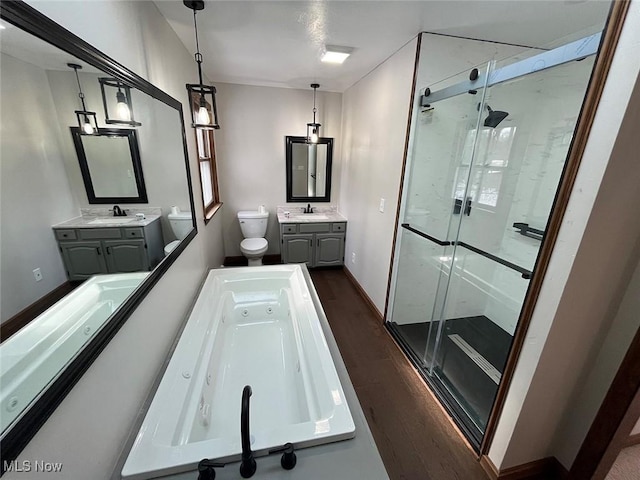 full bathroom with vanity, wood-type flooring, plus walk in shower, and toilet