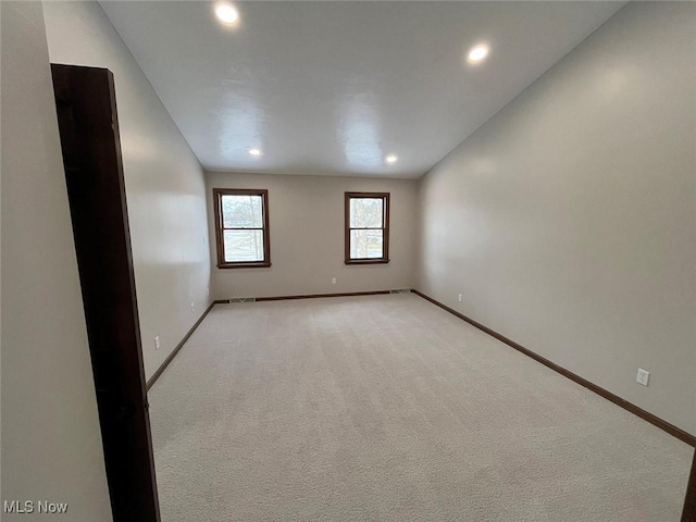 empty room featuring light colored carpet