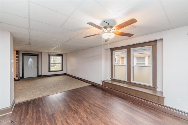 unfurnished room featuring hardwood / wood-style floors, a drop ceiling, and ceiling fan