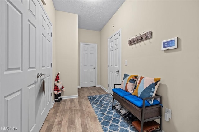 interior space with a textured ceiling and hardwood / wood-style flooring