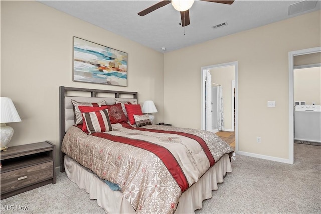 bedroom featuring ceiling fan, washer / clothes dryer, light carpet, and connected bathroom