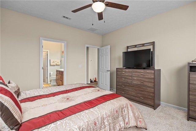 carpeted bedroom with ceiling fan and ensuite bathroom