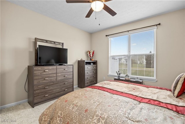 bedroom featuring light colored carpet and ceiling fan