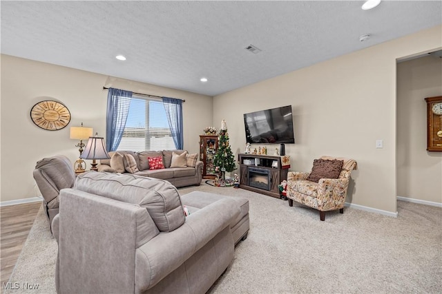 carpeted living room featuring a textured ceiling