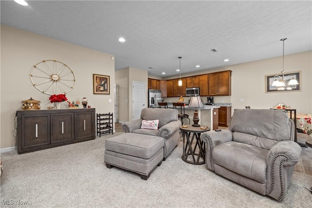 carpeted living room featuring a textured ceiling and an inviting chandelier