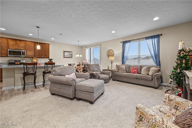 living room featuring a textured ceiling and light hardwood / wood-style flooring