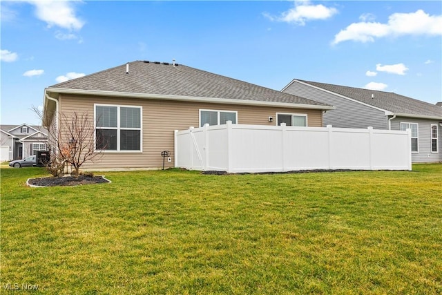 back of house featuring a yard