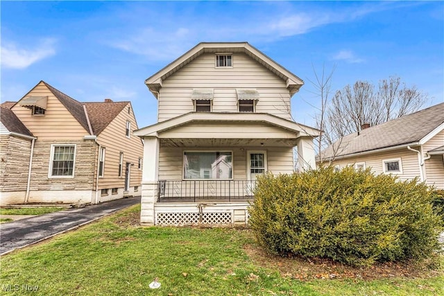 view of front of home featuring covered porch and a front yard