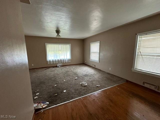 spare room featuring ceiling fan and hardwood / wood-style floors