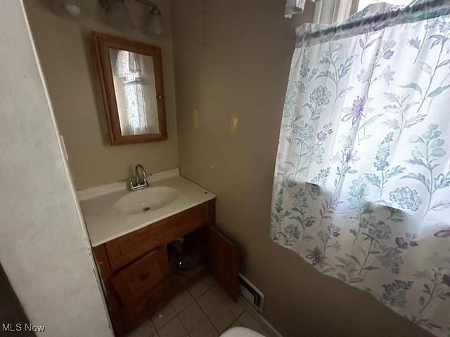 bathroom with tile patterned flooring and vanity