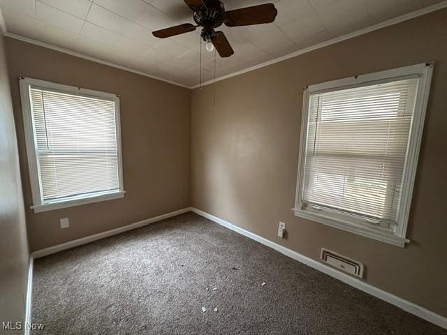 carpeted empty room featuring ceiling fan and ornamental molding