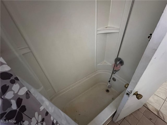 bathroom featuring tile patterned floors and bathtub / shower combination