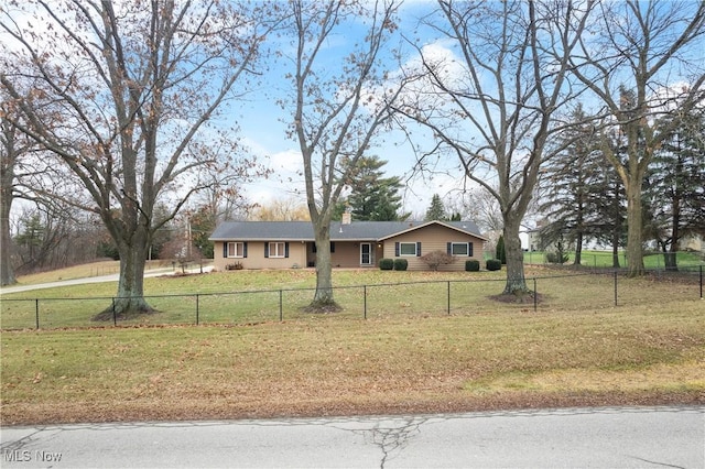 ranch-style home featuring a front yard