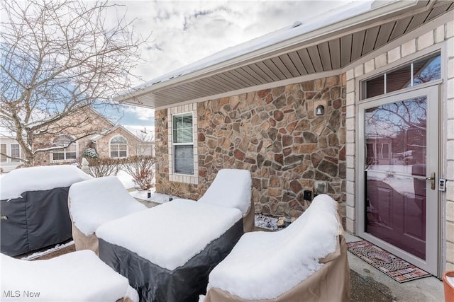 snow covered patio featuring grilling area