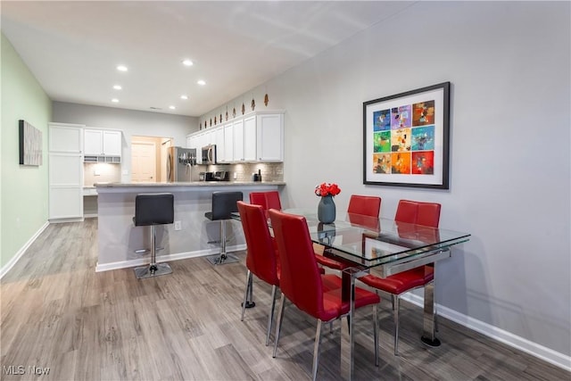 dining space featuring light wood-type flooring