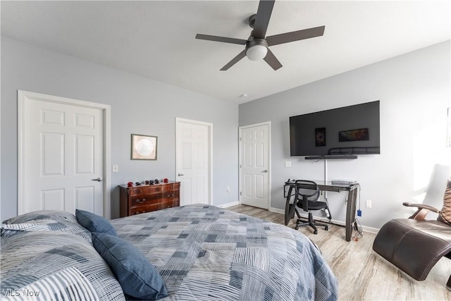 bedroom with light hardwood / wood-style flooring and ceiling fan