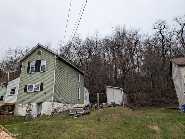 view of property exterior featuring a shed and a lawn