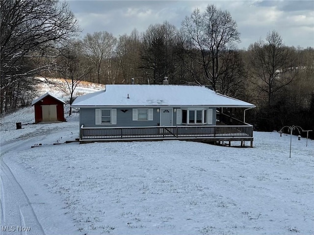 view of front of property with an outdoor structure and a wooden deck