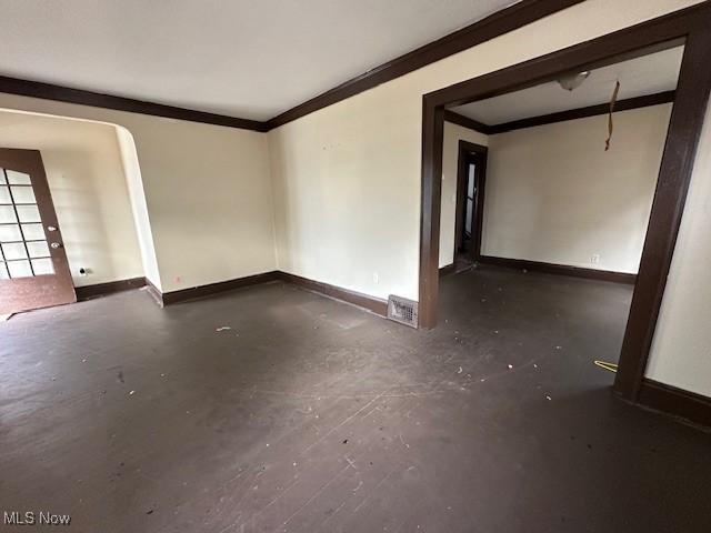 unfurnished room with crown molding