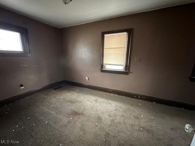 additional living space with carpet, a textured ceiling, and vaulted ceiling