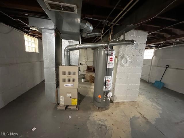 utility room featuring water heater