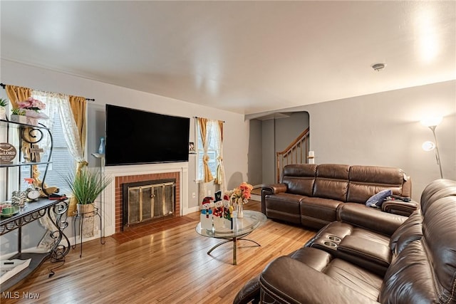 living room with a fireplace and hardwood / wood-style flooring