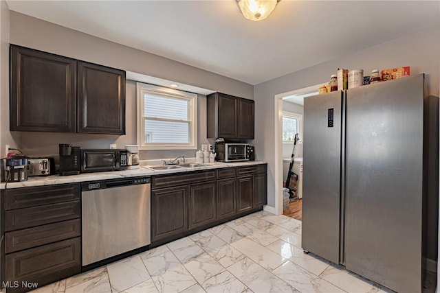 kitchen featuring sink, dark brown cabinetry, and stainless steel appliances