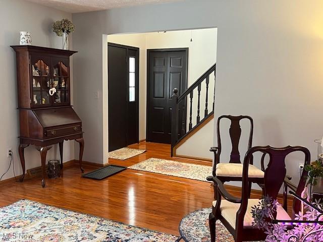 foyer entrance featuring light hardwood / wood-style floors and a textured ceiling