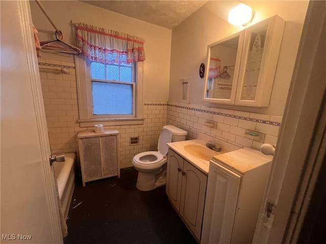 bathroom with a tub, radiator heating unit, toilet, vanity, and tile walls