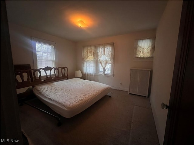 carpeted bedroom featuring multiple windows