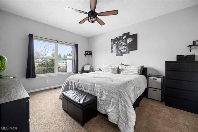 carpeted bedroom with a textured ceiling and ceiling fan