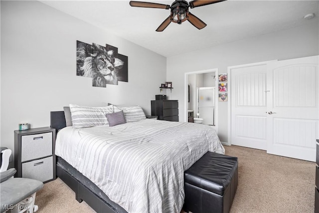 carpeted bedroom with ceiling fan and ensuite bathroom