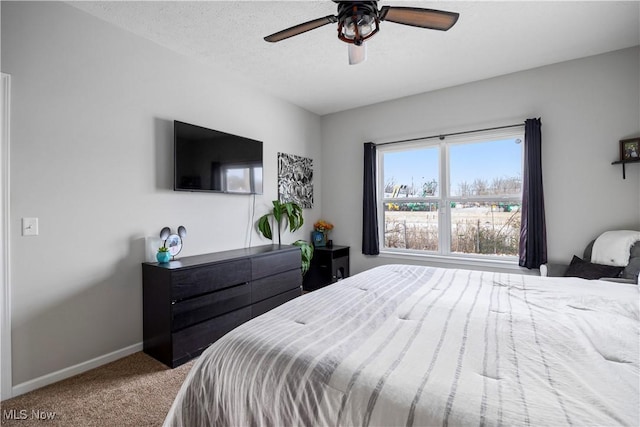 bedroom featuring ceiling fan, carpet, and a textured ceiling