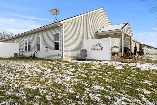 snow covered back of property featuring cooling unit