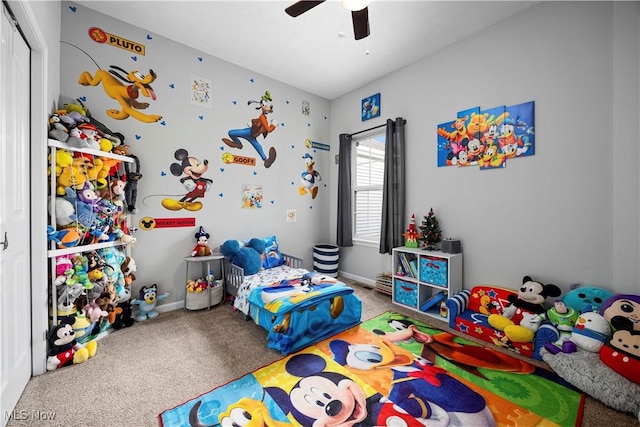 carpeted bedroom featuring ceiling fan and a closet