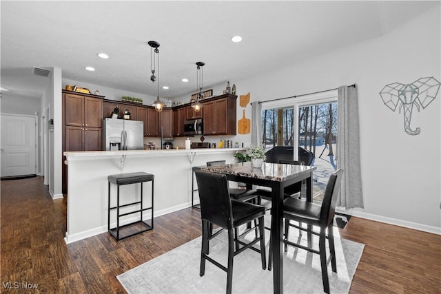 dining room with dark wood-type flooring