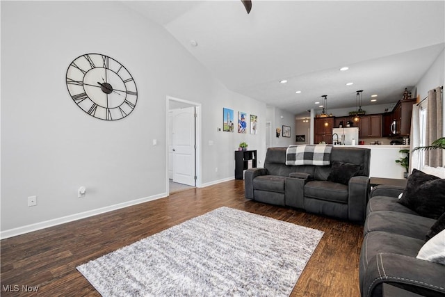 living room featuring dark hardwood / wood-style flooring and lofted ceiling