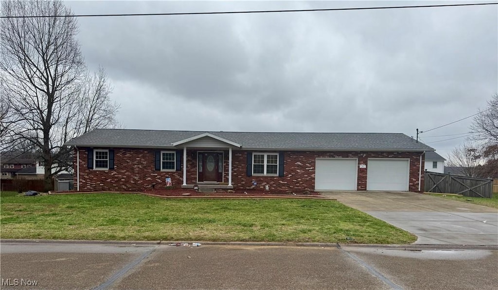 single story home featuring a front yard and a garage